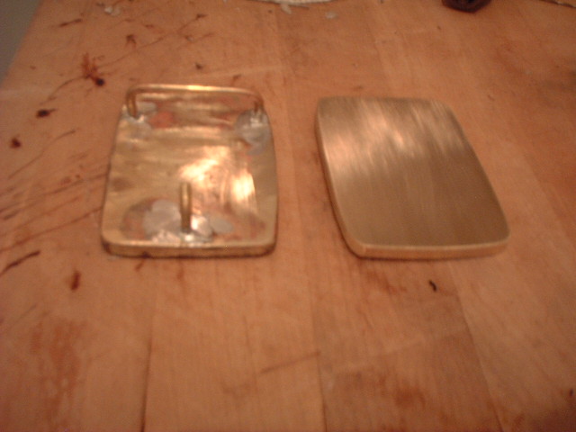 The backside of the buckle showing the loop and the tooth.